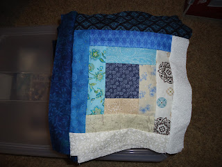 Blue log cabin quilt block folded on container