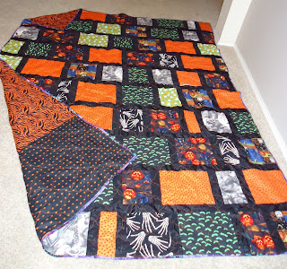Halloween-themed patchwork quilt with orange and black
