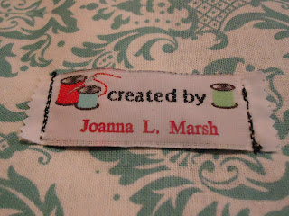 Sewn fabric label reading "Created by
