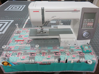 White Janome sewing machine on fabric organizer