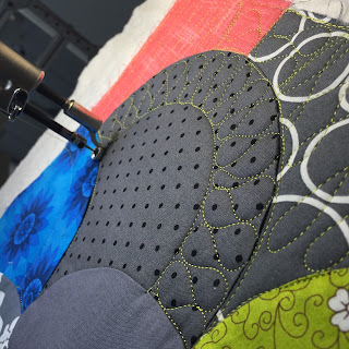 Close-up of quilting machine stitching circular patchwork