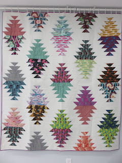 Colorful triangular patchwork quilt on white background
