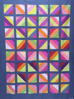 Colorful patchwork quilt with diagonal striped squares