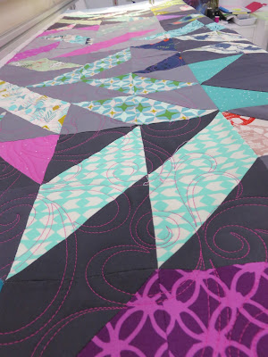 Colorful geometric star quilt on sewing table