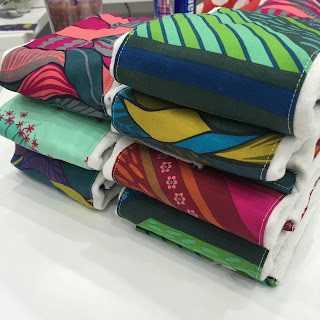 Stack of colorful patterned cloth diapers