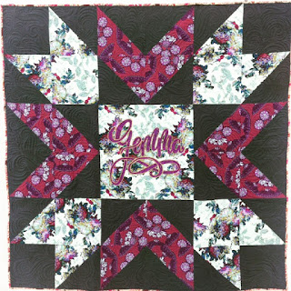 Purple floral patchwork quilt with chevron blocks
