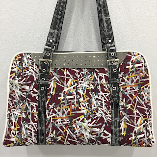 Colorful patterned handbag with black straps
