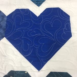 A close up of the heart on a quilt