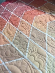 A close up of the quilted fabric on a quilt