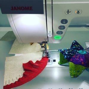A sewing machine with some fabric on it