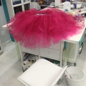 A pink tutu is on top of the table.