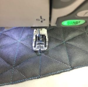 A sewing machine with the needle in its foot.