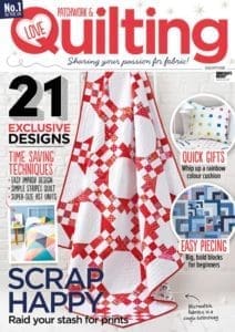 A magazine cover with some red and white quilt designs.