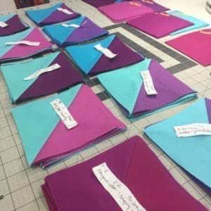 A group of folded paper books on top of each other.