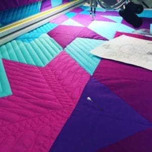A quilt being made on the sewing machine.