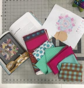 A table with some fabric and books on it