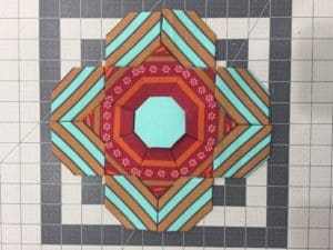 A quilt with a large octagonal design on it.