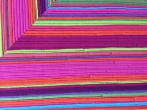 A colorful wall with many different colored strips.