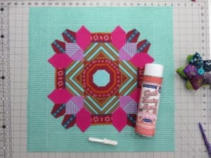 A quilt with a pink and purple design on it.