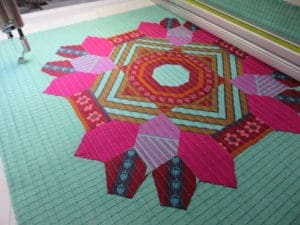 A quilt is being made on the floor.