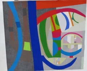 A painting of various colors and shapes on paper.