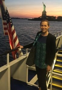 A woman standing on the deck of a boat.