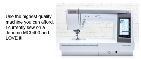 A white sewing machine sitting on top of a table.