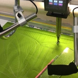 A green floor with a monitor and some wires