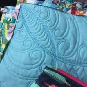A close up of the quilt and purse