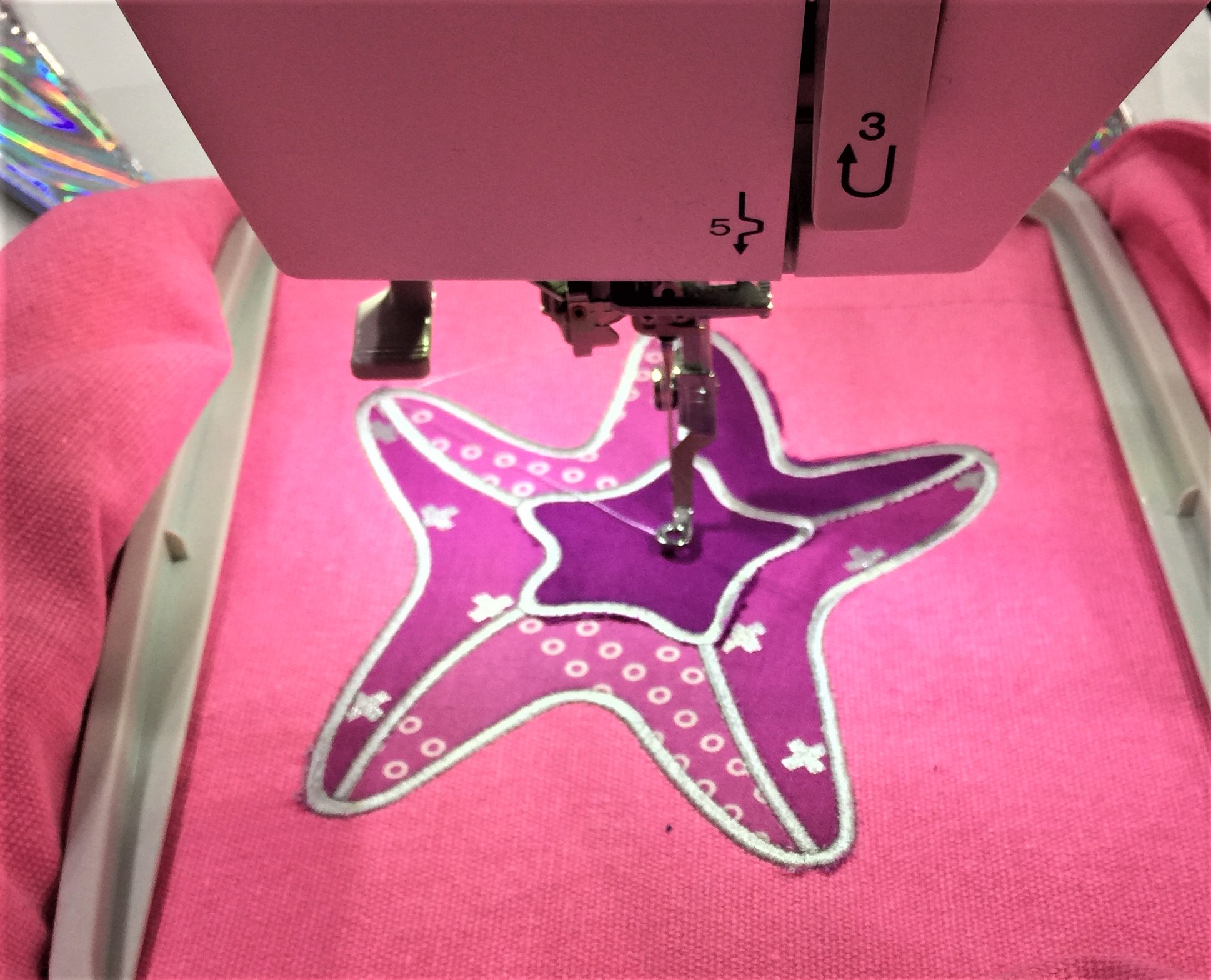 A pink machine with a purple star on it.
