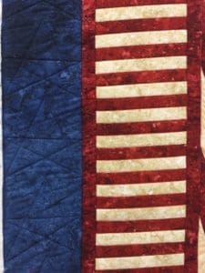 A close up of the american flag quilt