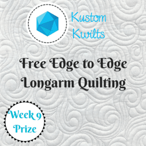 A white quilt with blue lettering and a picture of a blue diamond.