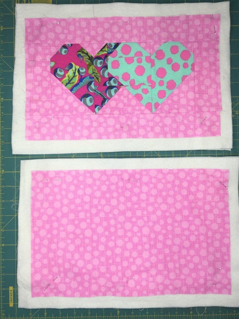 A pink and blue heart on top of black and white stripes.