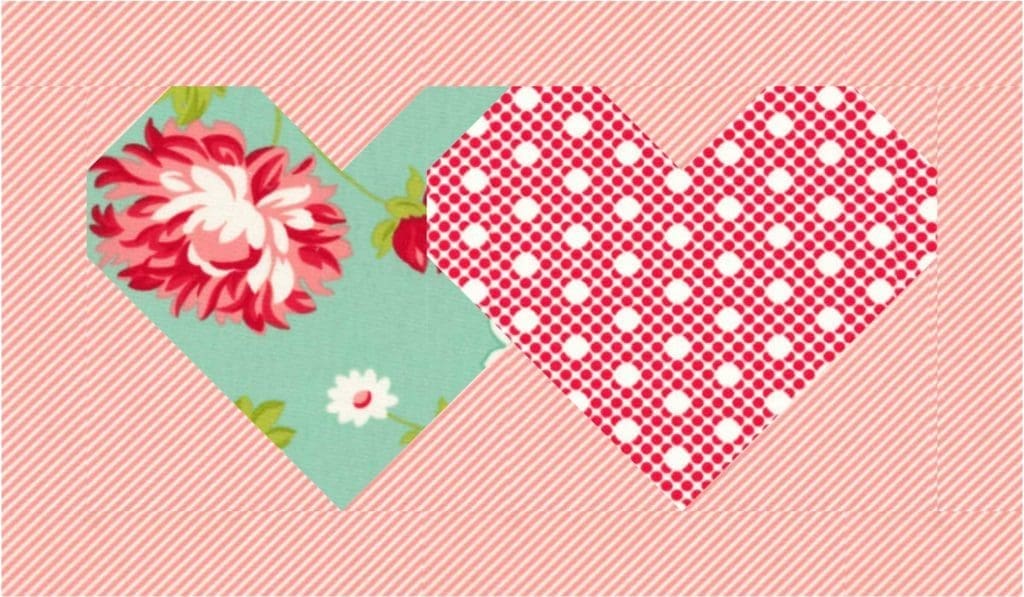 A heart shaped fabric with flowers and polka dots.