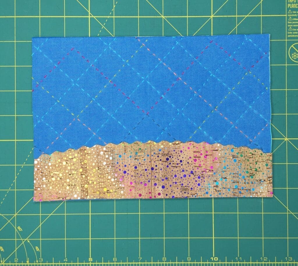 A piece of paper with blue and gold fabric on it.