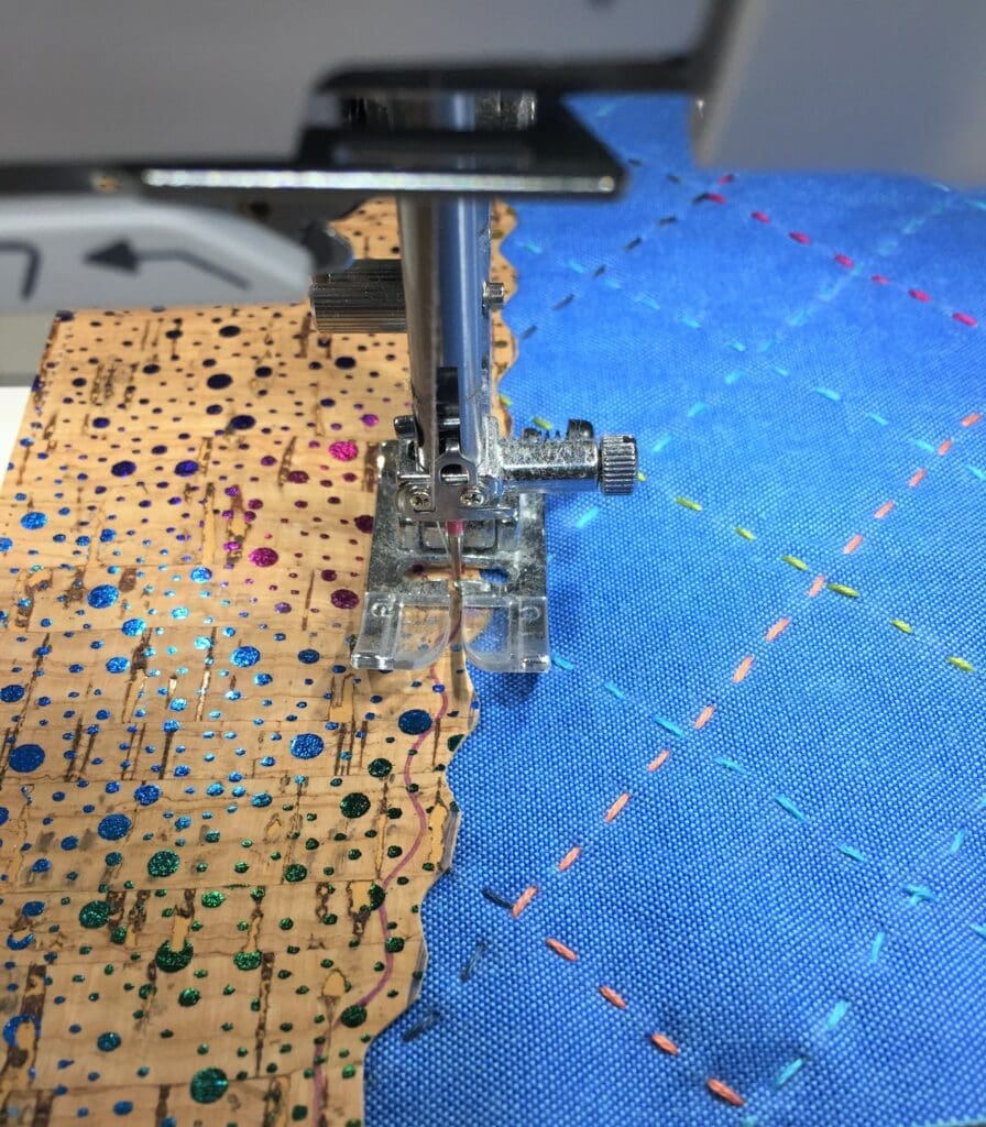 A sewing machine is cutting fabric with holes.