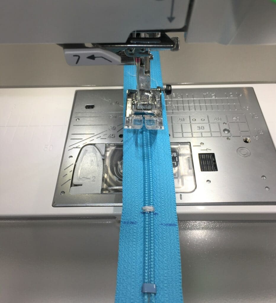 A sewing machine with blue fabric on it