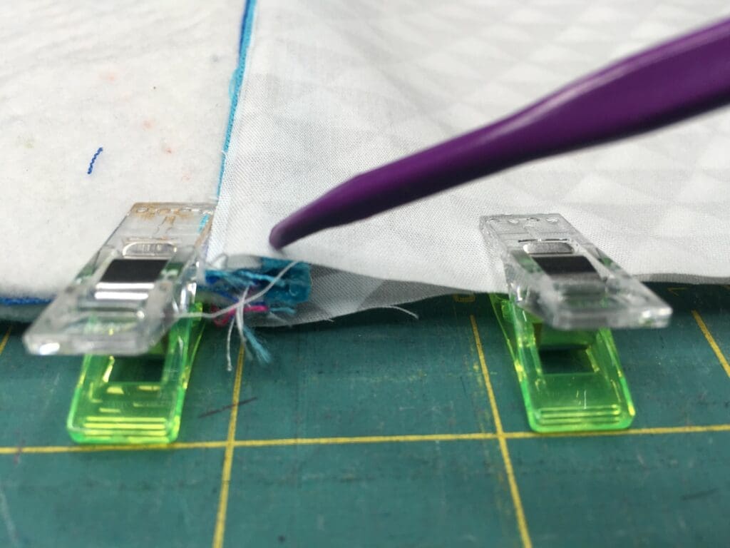 A pair of green plastic pegs are on the ground.