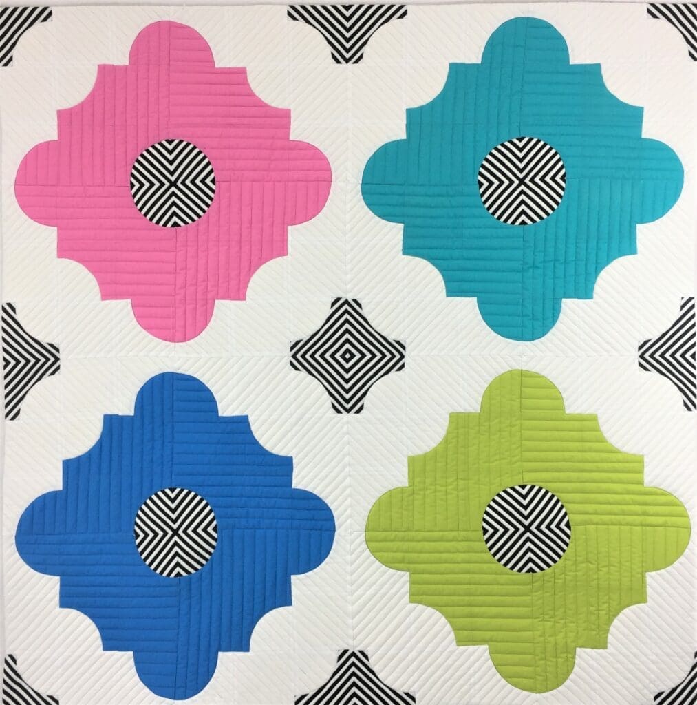 A colorful tile with four different designs on it.