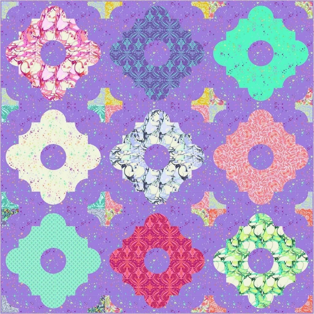 A purple quilt with different colored flowers on it.