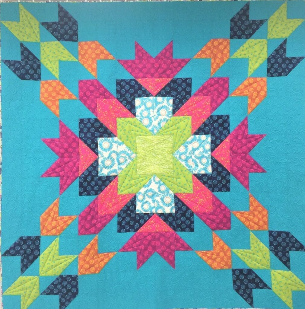 A quilt with colorful designs on it.