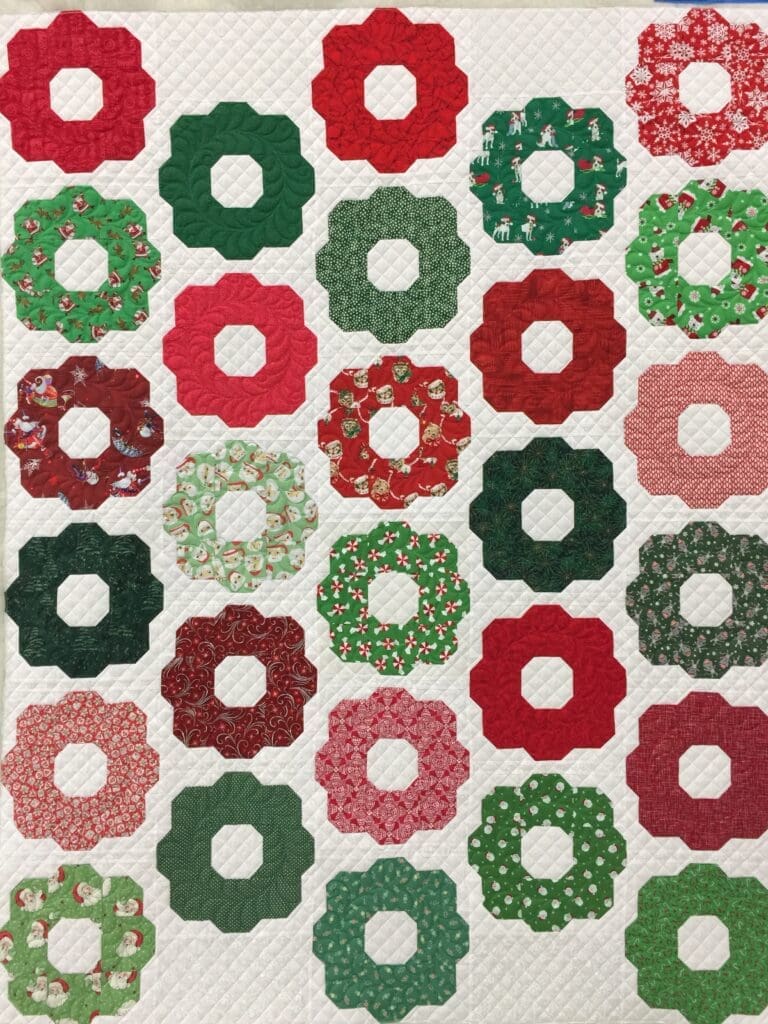 A quilt with many different colored circles on it.