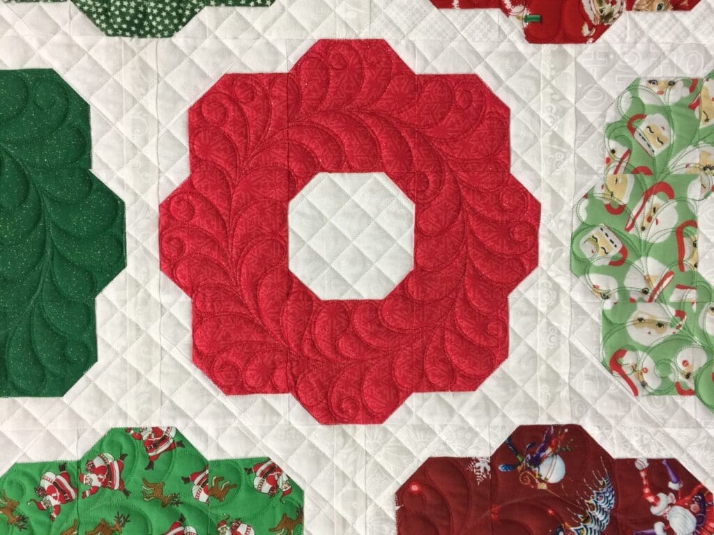 A close up of the quilt with the letter o