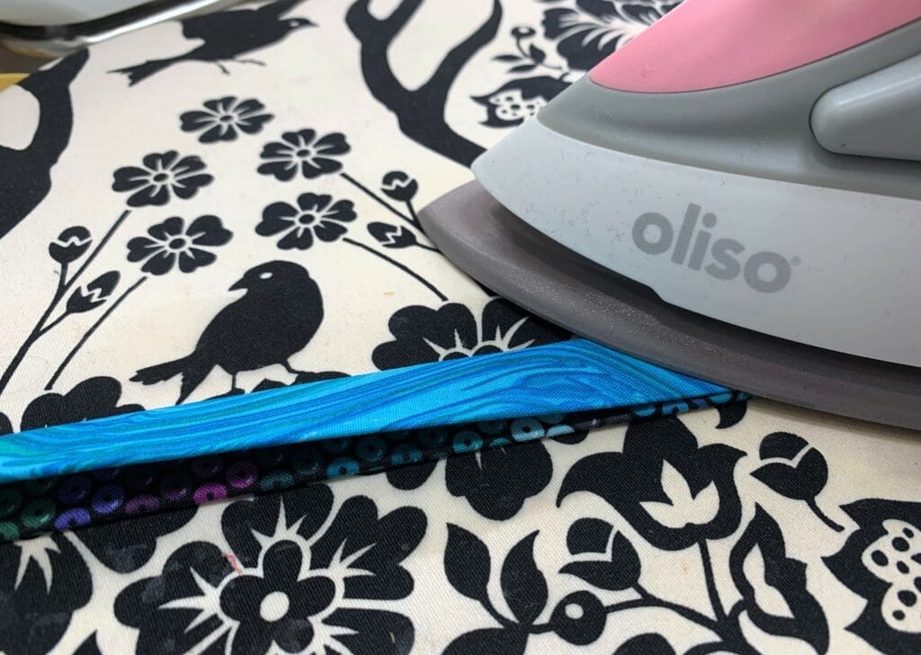 A close up of an iron on fabric