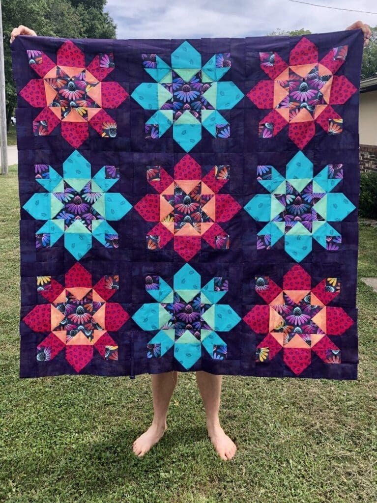A person standing in the grass with their feet up.