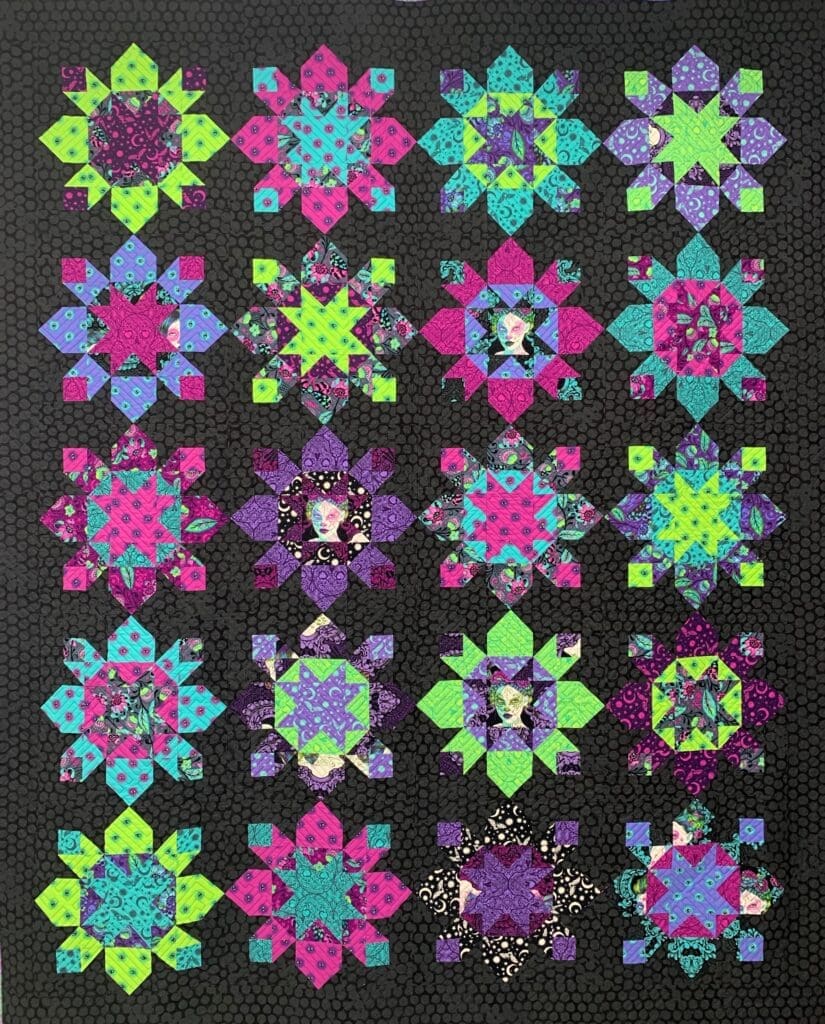 A quilt with different colored designs on it.