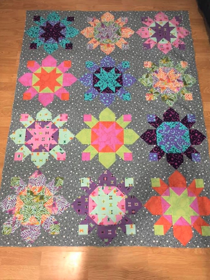 A quilt with different colored designs on it