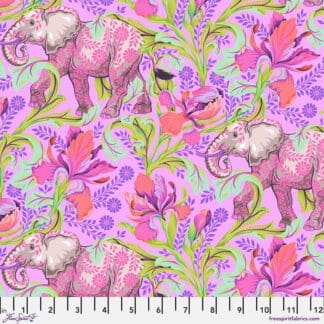 A pink elephant with flowers on it's back.