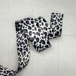 A black and white leopard print ribbon on a table.