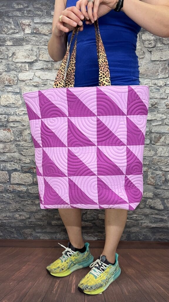 Purple geometric quilted tote bag with leopard handles